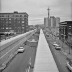 Monorail. Installing Rails. North of Virginia St. [and Space Needle under Construction], Nov. 1961 (Engineering Department Photographic Negatives)