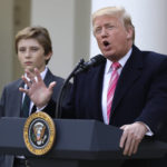 President Donald Trump speaks before he pardons Drumstick and Wishbone at the National Thanksgiving Turkey pardoning ceremony in the Rose Garden of the White House, Tuesday, Nov. 21, 2017, in Washington, as son Barron Trump watches. (AP Photo/Evan Vucci)