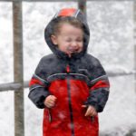 A young boy enjoys a windy day in Seattle. (Elaine Thompson, Associated Press)