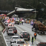 A derailed train is seen on southbound Interstate 5 on Monday, Dec. 18, 2017, in DuPont, Wash. An Amtrak train making an inaugural run on a new route derailed south of Seattle on Monday, spilling train cars onto a busy interstate in an accident that resulted in "multiple fatalities" and numerous injuries, authorities said.  (AP Photo/Rachel La Corte)