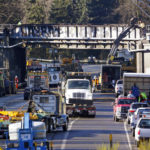 Vehicles fill the highway at the scene of an Amtrak train crash onto Interstate 5 from the railroad bridge above two days earlier Wednesday, Dec. 20, 2017, in DuPont, Wash. The Amtrak train that careened off the overpass south of Seattle, killing at least three people, was hurtling 50 mph over the speed limit when it jumped the track, federal investigators say, when it derailed along a curve, spilling railcars onto the highway below. (AP Photo/Elaine Thompson)