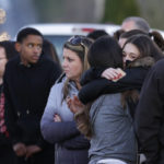 
              Two people hug as they wait to be reunited with students on lockdown near Graham-Kapowsin High School, Frontier Middle School, and Nelson Elementary School, Tuesday, Dec. 5, 2017, in Graham, Wash. Authorities said two students were shot near the high school Tuesday afternoon. (AP Photo/Ted S. Warren)
            