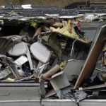 
              Seats are jammed together with other debris on an upside-down Amtrak train car sitting on a flat bed trailer taken from the scene of Monday's deadly crash onto Interstate 5 Tuesday, Dec. 19, 2017, in DuPont, Wash. The Amtrak train that plunged off an overpass south of Seattle was hurtling 50 mph over the speed limit when it jumped the track, federal investigators said. (AP Photo/Elaine Thompson)
            