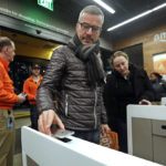 
              A customer scans his Amazon Go cellphone app at the entrance as he heads into an Amazon Go store, Monday, Jan. 22, 2018, in Seattle. The store, which opened to the public on Monday, allows shoppers to scan their smartphone with the Amazon Go app at a turnstile, pick out the items they want and leave. The online retail giant can tell what people have purchased and automatically charges their Amazon account. (AP Photo/Elaine Thompson)
            