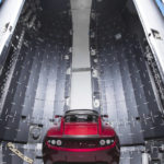 
              This Dec. 6, 2017 photo made available by SpaceX shows a Tesla car next to the fairing of a Falcon Heavy rocket in Cape Canaveral, Fla. For the Heavy's inaugural flight, the rocket will carry up Elon Musk's roadster. In addition to SpaceX, Musk runs the electric car maker Tesla. 
(SpaceX via AP)
            