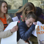 
              East chapel Hill students hug as they take part in a student walkout on Wednesday, March 14, 2018, in Chapel Hill, N.C.  Students across the country participated in walkouts Wednesday to protest gun violence, one month after a deadly shooting inside a high school in Parkland, Fla.   (Bernard Thomas/The Herald-Sun via AP)
            