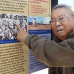 Kenso Zenimura, an 89-year-old former Japanese professional baseball player, points to a photo showing him held at an internment camp for Japanese immigrants and Japanese-Americans during World War II in Chandler. (Kyodo via AP Images)