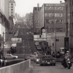 A motorcade of dignitaries celebrated the opening of the Columbia Street on-ramp to southbound 99 on the Alaskan Way Viaduct in January 1966, nearly 12 years after the elevated roadway was completed and opened to traffic. (Downtown Seattle Association/UW Special Collections)