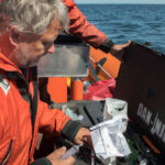 Dr. Martin Haulena of the Vancouver Aquarium and Jeff Foster of the Whale Sanctuary Project, prepare antibiotics to administer to J50, Aug. 9, 2018. (Katy Foster/NOAA Fisheries)