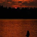 Going fishing under the sunset over Seattle's Green Lake amid a thick smoky haze from wildfire smoke, August 2018. (National Weather Service Seattle)