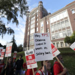 
              A striking teacher carries a sign that reads "Hey TPS, Oklahoma called. It wants its salary back," as she marches around the Tacoma School District Central Administration Building, Monday, Sept. 10, 2018, in Tacoma, Wash. Teachers in the district have been on strike since last week. (AP Photo/Ted S. Warren)
            