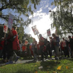 
              Striking teachers carry picket signs as they march around the Tacoma School District Central Administration Building, Monday, Sept. 10, 2018, in Tacoma, Wash. Teachers in the district have been on strike since last week. (AP Photo/Ted S. Warren)
            