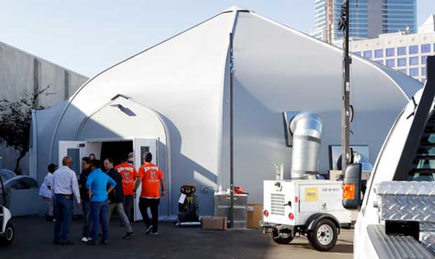 Crews work in front of the the city's new Temporary Bridge Shelter for the homeless Friday, Dec. 1,...