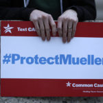 
              A protester holds a sign during a rally outside the Guilford County Courthouse against President Trump's Attorney General move that could jeopardize the special counsel's work in Greensboro, N.C., Thursday, Nov. 8, 2018. (AP Photo/Chuck Burton)
            