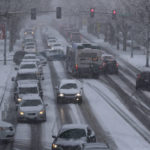 
              Cars and a bus make their way in the snow on Capitol Way, Friday, Feb. 8, 2019, in Olympia, Wash. A much-anticipated winter storm hit Washington state Friday, and many businesses, schools, and offices closed early so workers could get home. State and local officials urged people to stay off the roads as traffic slowed to a standstill in some places because of the snow. (AP Photo/Ted S. Warren)
            