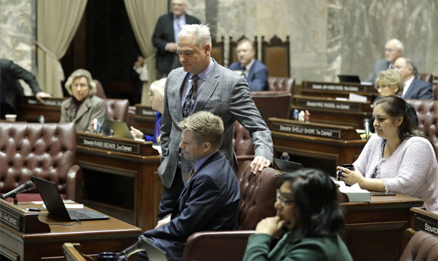 Sen. Reuven Carlyle, D-Seattle, standing center, watches with Sen. Jaime Pedersen D-Seattle, seated...