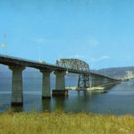 The original mile-long Hood Canal floating bridge carried cars and trucks across the mouth of Hood Canal; the western portion of the bridge sank in a windstorm on February 13, 1979. (Washington State Archives)