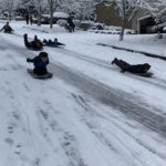 A Bothell police officer goes sledding. (City of Bothell screengrab)