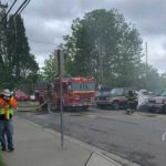 Construction and office workers choke on smoky air as emergency crews respond to a waterfront fire in Seattle's Eastlake neighborhood. (Aaron Granillo, KIRO Radio)