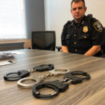 Seattle Deputy Chief Marc Garth Green showing the new and old models of handcuffs used by the Seattle Police Department. (Dyer Oxley, MyNorthwest)