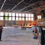 Nicole Klein (seated, right) says the restored hangar will function as a museum as well as a place for special events. (Feliks Banel)