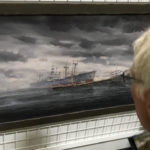 Puget Sound Maritime Historical Society volunteer and longtime Foss employee Mike Skalley examines a painting of the wreck of the Diamond Knot and the Fenn Victory at the PSMHS archives in Georgetown. (Feliks Banel)
