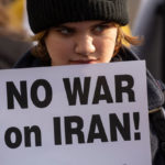 An anti-war demonstrator holds a sign during a rally on January 4, 2020 in Seattle, Washington. Groups held rallies across the U.S. Saturday in response to increased tensions in the Middle East as a result of a U.S. airstrike that killed an Iranian general last week. (Photo by David Ryder/Getty Images)