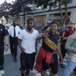 
              Seattle Fire Assistant Chief Willie Barrington, left, and Chief Harold Scoggins, second from left, walk with protest organizers, Friday, June 26, 2020 inside the CHOP (Capitol Hill Occupied Protest) zone in Seattle. The officials were on hand to try and negotiate with protesters after workers and trucks from the Seattle Department of Transportation who had arrived with the intention of removing barricades were met with resistance. The area has been occupied by protesters since Seattle Police pulled back from their East Precinct building following violent clashes with demonstrators earlier in the month. (AP Photo/Ted S. Warren)
            