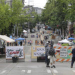 
              A sign on a barricade reads "Welcome to CHOP," Saturday, June 20, 2020, at the intersection of 10th Ave. and Pine St. at the Capitol Hill Occupied Protest zone in Seattle. A pre-dawn shooting near the area left one person dead and critically injured another person, authorities said Saturday. The area has been occupied by protesters after Seattle Police pulled back from several blocks of the city's Capitol Hill neighborhood near the Police Department's East Precinct building. (AP Photo/Ted S. Warren)
            