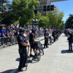 Seattle officers hold the line to help separate the agitators from the much larger pro-police crowd. (Photo: Jason Rantz)