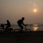 SEATTLE, WA - SEPTEMBER 11:  People bike along Harbor Avenue SW in West Seattle as smoke from wildfires fills the air on September 11, 2020 in Seattle, Washington. According to reports, air quality is expected to worsen as smoke from dozens of wildfires in forests of the Pacific Northwest and along the West Coast descends onto the region. (Photo by Lindsey Wasson/Getty Images)