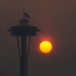 SEATTLE, WA - SEPTEMBER 11:  The Space Needle flies an American flag at half-mast in remembrance of the September 11 attacks as the sun sets through wildfire smoke on September 11, 2020 in Seattle, Washington. According to reports, air quality is expected to worsen as smoke from dozens of wildfires in forests of the Pacific Northwest and along the West Coast descends onto the region. (Photo by Lindsey Wasson/Getty Images)