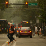SEATTLE, WA - SEPTEMBER 12:  People wear masks as they cross a street near Pike Place Market as smoke from wildfires fills the air on September 12, 2020 in Seattle, Washington. According to the National Weather Service, the air quality in Seattle remained at "unhealthy" levels Saturday after a large smoke cloud from wildfires on the West Coast settled over the area. (Photo by Lindsey Wasson/Getty Images)