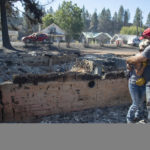 
              Shawn Thornton hugs his wife, Shannon Thornton, next to the rubble of their burned home Tuesday, Sept. 8, 2020, in Malden, Washington the day after a fast-moving wildfire swept through the tiny town west of Rosalia. Shawn and Shannon weren't home at the time, but their son Cody was and managed to get their dog and a few belongings before leaving just minutes before the flames swept through.  (Jesse Tinsley/The Spokesman-Review via AP)
            