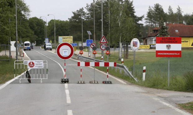 FILE - In this May 13, 2020 file photo, a barrier blocks the road at the closed border crossing fro...