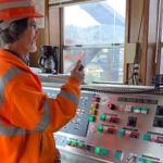 Operator Butch Elsasser stands at a control panel for the Salmon Bay Bridge. (BNSF Railway)