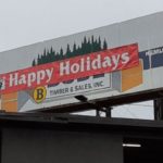 The south facing Buse Timber sign says "Happy Holidays." (Buse Timber)