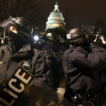 WASHINGTON, DC - JANUARY 06: Police officers in riot gear work to disperse protesters who are gathering at the U.S. Capitol Building on January 06, 2021 in Washington, DC. Pro-Trump protesters entered the U.S. Capitol building after mass demonstrations in the nation's capital during a joint session Congress to ratify President-elect Joe Biden's 306-232 Electoral College win over President Donald Trump. (Photo by Tasos Katopodis/Getty Images)