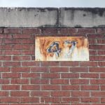 During Magnuson Park’s earlier Navy base era, the structure was officially known as Building 47; a faded and peeling old sign is still attached to the west exterior wall. (Feliks Banel/KIRO Radio)