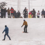 People play in the snow amidst persistent snowfall on Feb.13, 2021 in Seattle, Washington. (Photo by David Ryder/Getty Images)