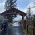 The wooden arch with the date of the Oso landslide is the newest piece of the memorial, located at each side of the entrance to the slide site. (Hanna Scott, KIRO Radio)