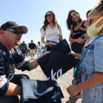 Ryan Mitchell hands out blankets to fans at the Seattle Kraken 2021 NHL expansion draft at Gas Works Park on July 21, 2021 in Seattle.  (Photo by Karen Ducey/Getty Images)