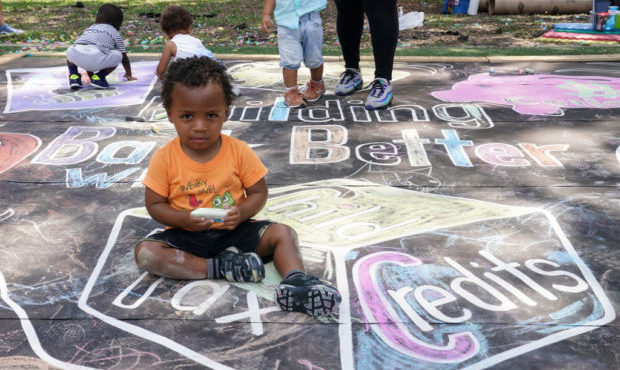 Children and teachers from the KU Kids Deanwood Childcare Center complete a mural in celebration of...