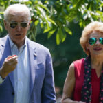 
              President Joe Biden eats a cherry as he tours King Orchards fruit farm Sen. Debbie Stabenow, D-Mich., Saturday, July 3, 2021, in Central Lake, Mich. (AP Photo/Alex Brandon)
            