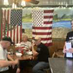 
              Pauline Bauer, right, speaks with customers from left, Ron Stevenson, 68, of Jamestown, N.Y., his cousin Glenn Robinson, 68, of Kane, Pa., and his half-brother Paul Boedecker, 71, of Warren, Pa., at Bauer’s restaurant, Bob’s Trading Post, Wednesday,  July 21, 2021, in Hamilton, Pa. Bauer is one of more than 540 people charged with federal crimes stemming from the Jan. 6 riot at the U.S. Capitol.  (AP Photo/Michael Kunzelman)
            