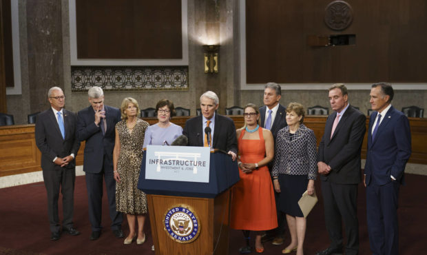 The bipartisan group of Senate negotiators speak to reporters just after a vote to start work on a ...