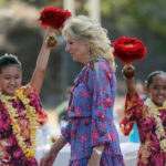 
              First lady Jill Biden walks past hula dancers with Ka Pa Nani o Lilinoe during a barbecue at the gym and recreation area of Makalapa Crater at Joint Base Pearl Harbor-Hickam, Hawaii, Sunday, July 25, 2021. The first lady met with more than 75 members of the military and their families before departing Hawaii for Washington on Sunday afternoon. (Jamm Aquino/Honolulu Star-Advertiser via AP)
            