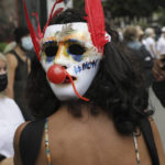 
              A protestor wears a mask on the back of her head which says "no" in French as she attends a demonstration in Paris, France, Saturday, July 31, 2021. Demonstrators gathered in several cities in France on Saturday to protest against the COVID-19 pass, which grants vaccinated individuals greater ease of access to venues. (AP Photo/Adrienne Surprenant)
            