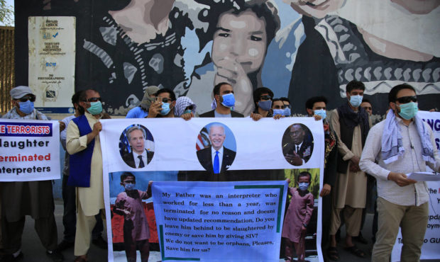 In this June 25, 2021 photo, Former Afghan interpreters hold placards during a demonstrations again...