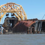 
              FILE - In this April 26, 2021 file photo, a towering crane pulls the engine room section away from the remains of the capsized cargo ship Golden Ray offshore of St. Simons Island, Ga.  Accounts contained in crew member interviews are among more than 1,700 pages of documents made public Thursday, July 29, by the National Transportation Safety Board. The Golden Ray, carrying more than 1,400 vehicles, overturned after leaving the Port of Brunswick along the Georgia coast on Sept. 8, 2019. Tennant and about two dozen crew members on board were rescued and survived.  (AP Photo/Russ Bynum, File)
            